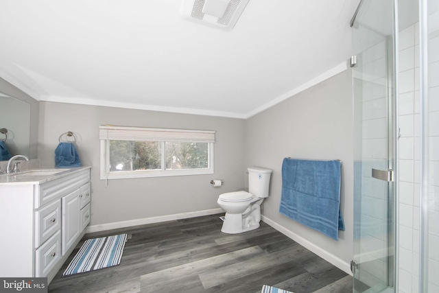 full bathroom with visible vents, a shower with door, wood finished floors, crown molding, and vanity