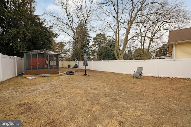 view of yard with a sunroom and a fenced backyard