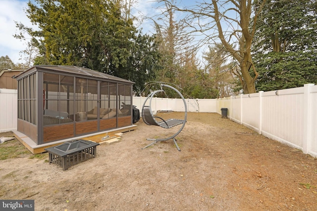 view of yard with a fenced backyard and a sunroom