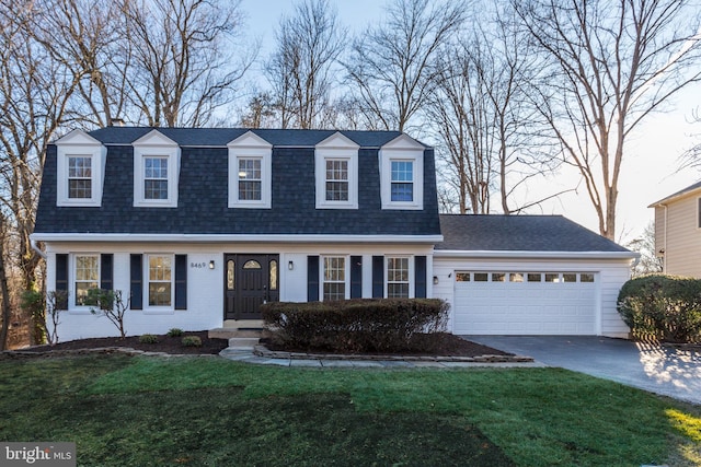 view of front of home with a front lawn, driveway, a shingled roof, and an attached garage