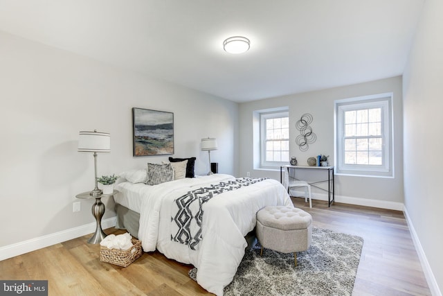 bedroom featuring baseboards and wood finished floors