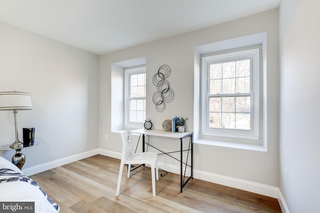 home office featuring light wood-type flooring and baseboards