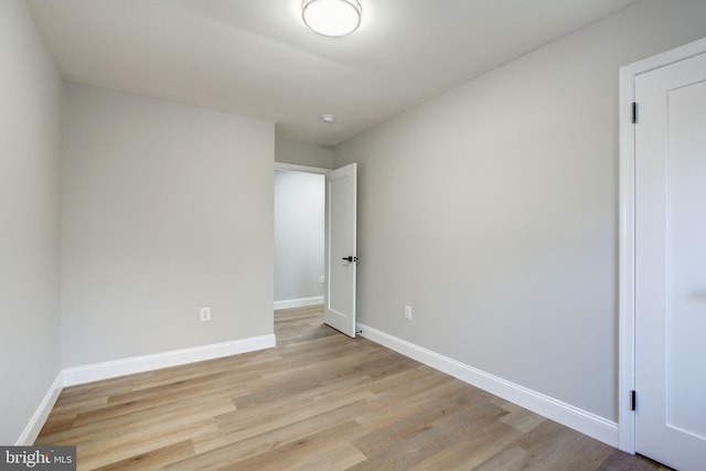 unfurnished bedroom with baseboards and light wood-style floors