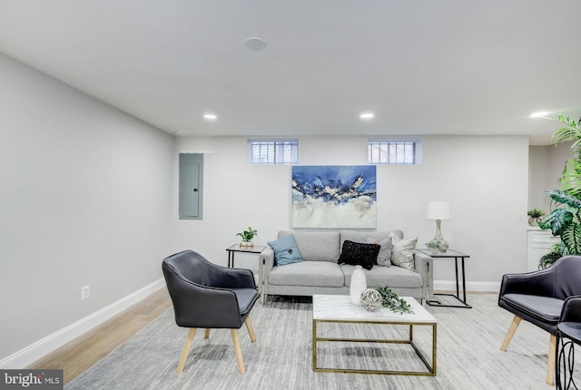 living area featuring electric panel, baseboards, wood finished floors, and recessed lighting