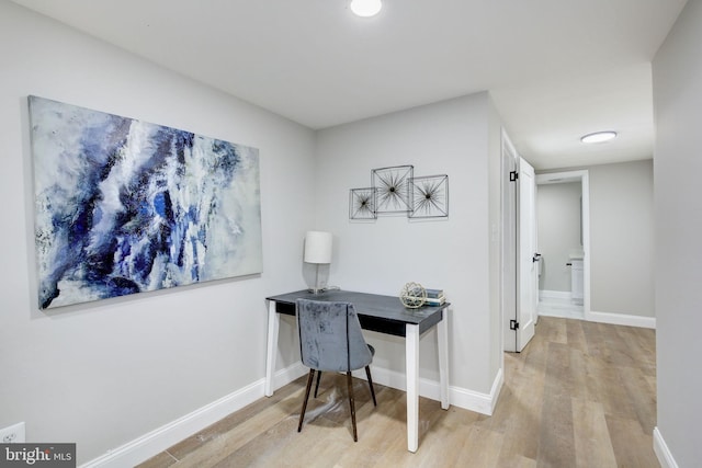 office area with light wood-type flooring and baseboards