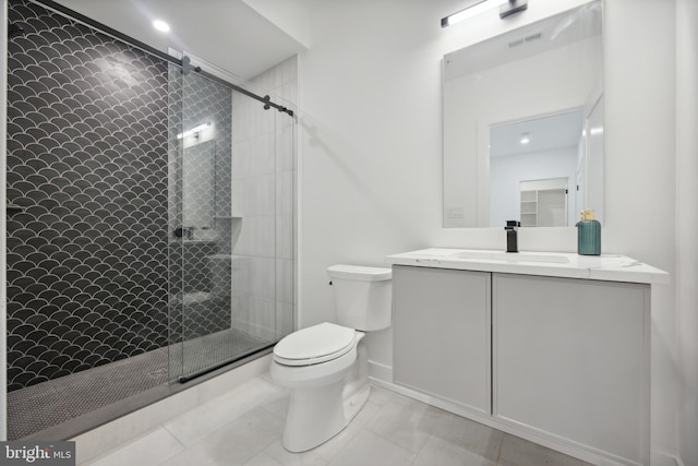 bathroom featuring vanity, an enclosed shower, and toilet