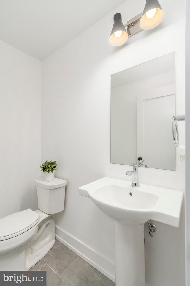 bathroom featuring tile patterned flooring and toilet