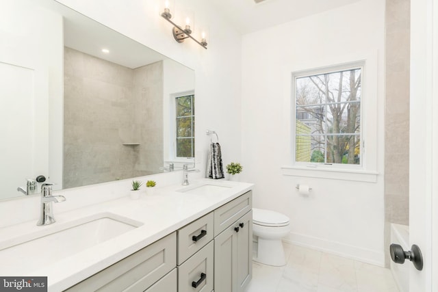 bathroom with vanity, a wealth of natural light, and toilet