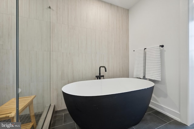 bathroom with a bath and tile patterned floors