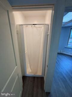 hallway with dark wood-type flooring