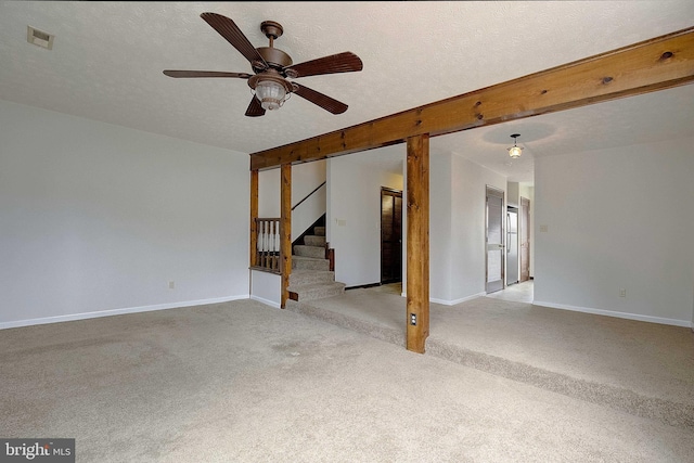 unfurnished room with visible vents, stairway, light carpet, a textured ceiling, and baseboards