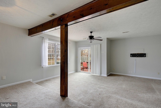 unfurnished room with ceiling fan, light colored carpet, visible vents, and baseboards