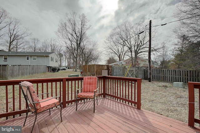 deck with a fenced backyard and a yard