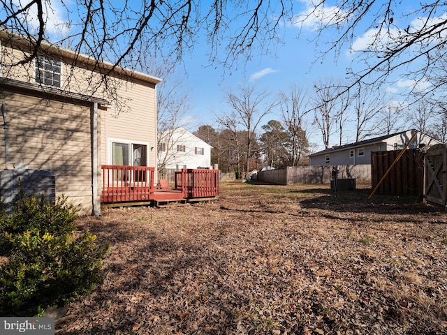 view of yard with a deck and fence