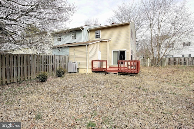 rear view of house featuring a fenced backyard, a wooden deck, and central AC unit