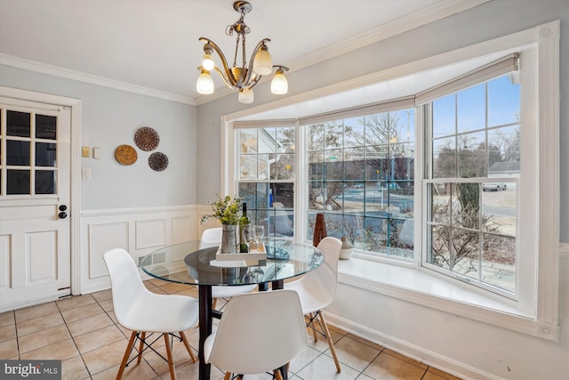 dining area featuring ornamental molding, a wealth of natural light, a notable chandelier, and light tile patterned floors