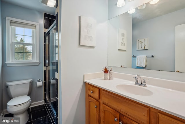 full bath featuring toilet, vanity, a shower stall, baseboards, and tile patterned floors