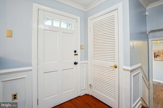 entryway featuring ornamental molding and dark wood-style floors