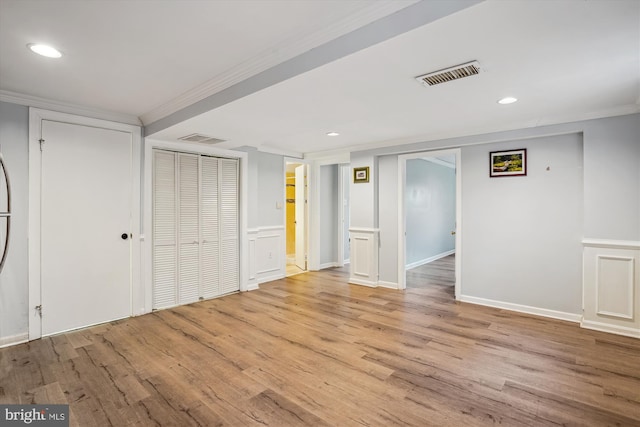 interior space with visible vents, crown molding, and light wood finished floors