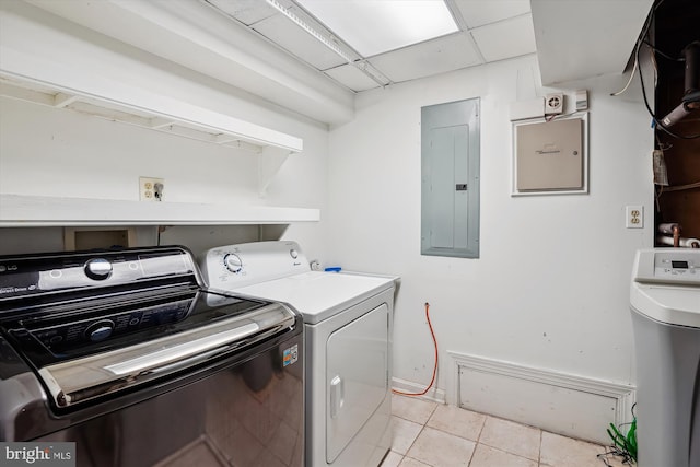 clothes washing area featuring laundry area, light tile patterned flooring, independent washer and dryer, and electric panel