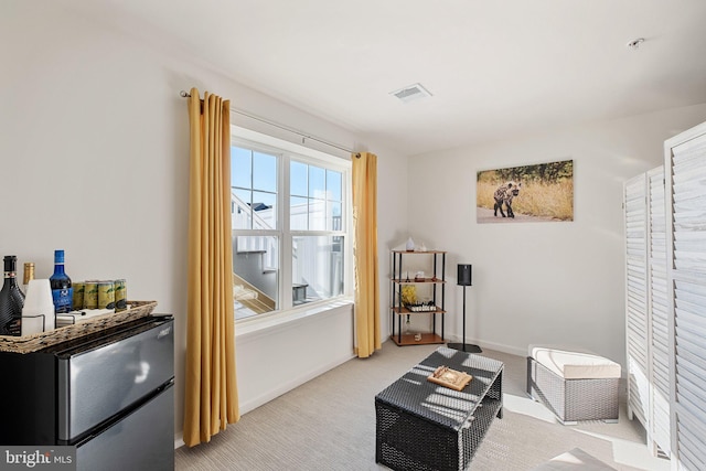 living area with light colored carpet