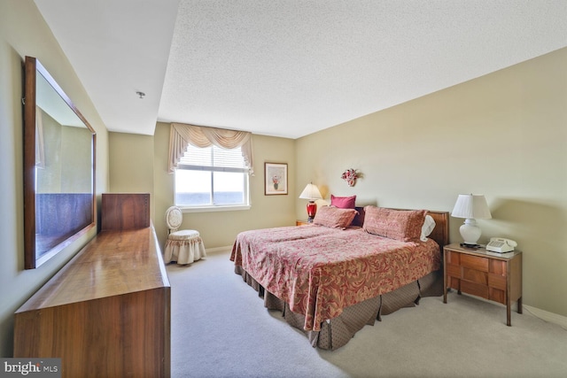 bedroom featuring carpet floors, a textured ceiling, and baseboards