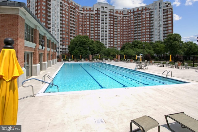 pool featuring a patio area and fence