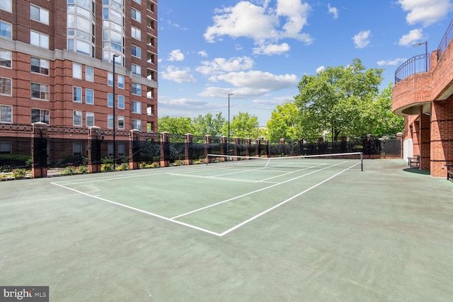 view of tennis court with fence