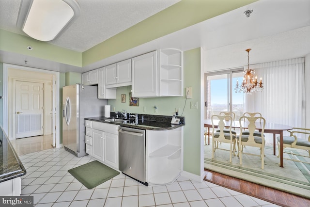 kitchen featuring open shelves, appliances with stainless steel finishes, a sink, and white cabinets