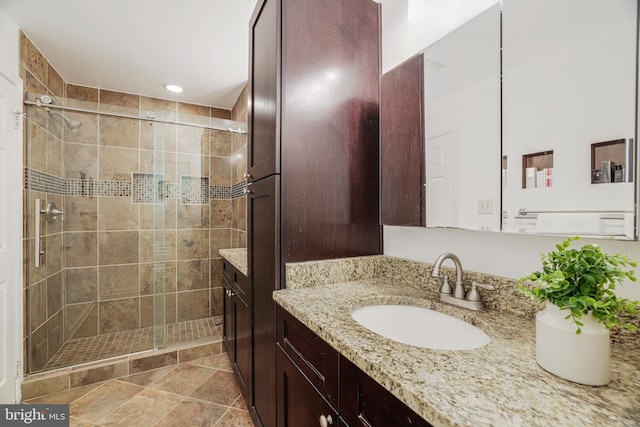 bathroom featuring a stall shower and vanity