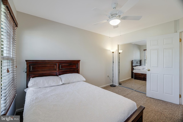 bedroom featuring light carpet, baseboards, and a ceiling fan