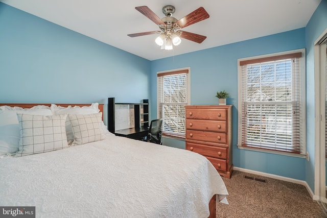 bedroom featuring carpet floors, visible vents, baseboards, and multiple windows