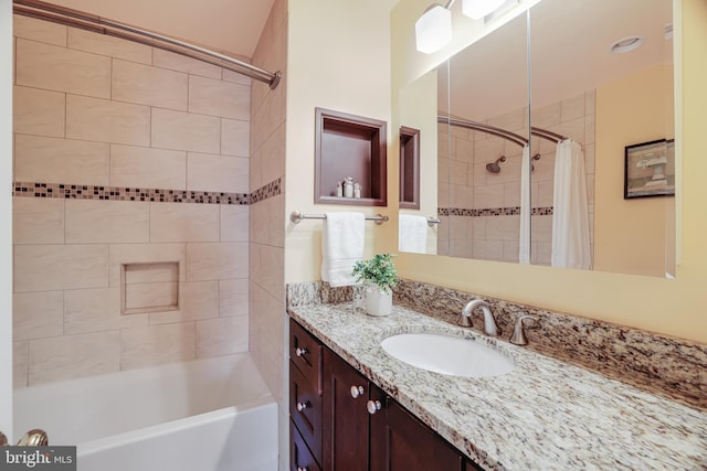 bathroom featuring shower / bath combo and vanity