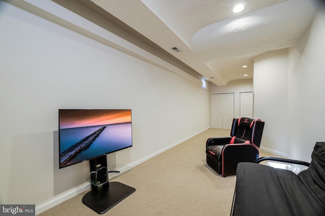 living area with carpet floors, visible vents, and baseboards