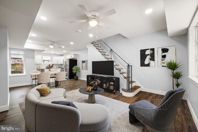 living room with dark wood-type flooring and ceiling fan