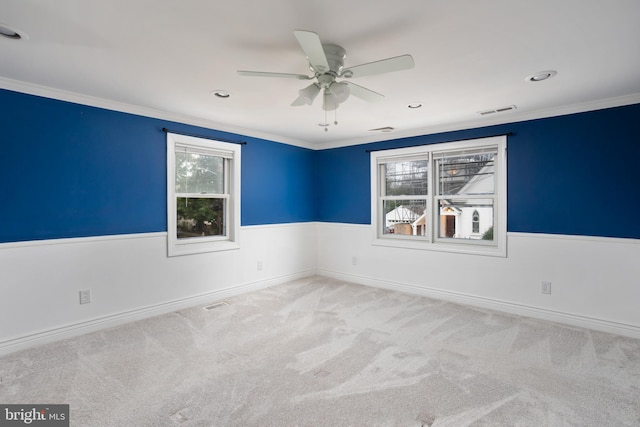 carpeted spare room with ornamental molding and ceiling fan