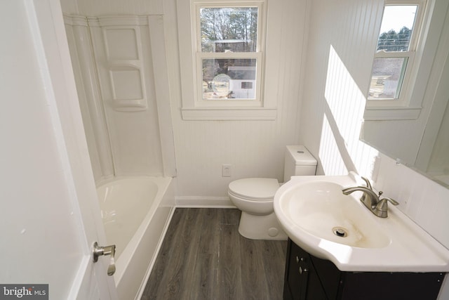 bathroom featuring wood-type flooring, toilet, and vanity