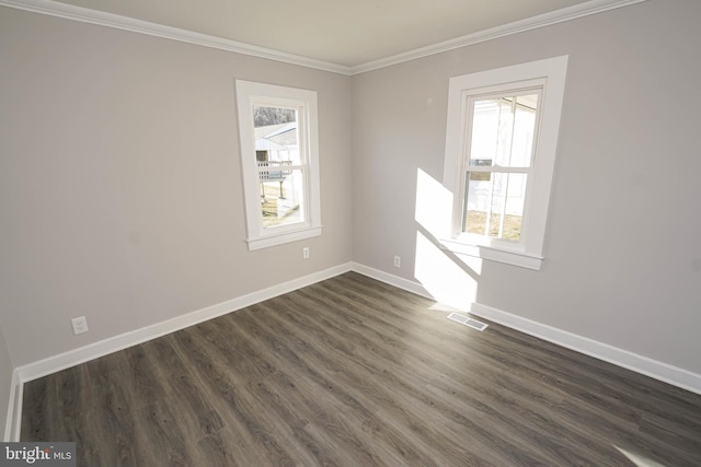 unfurnished room with ornamental molding, plenty of natural light, and dark hardwood / wood-style flooring