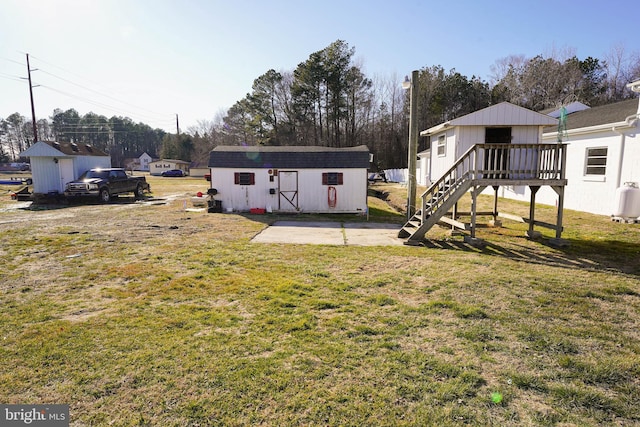 view of yard featuring a storage shed, a deck, and a patio area