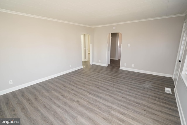 spare room featuring dark wood-type flooring and ornamental molding