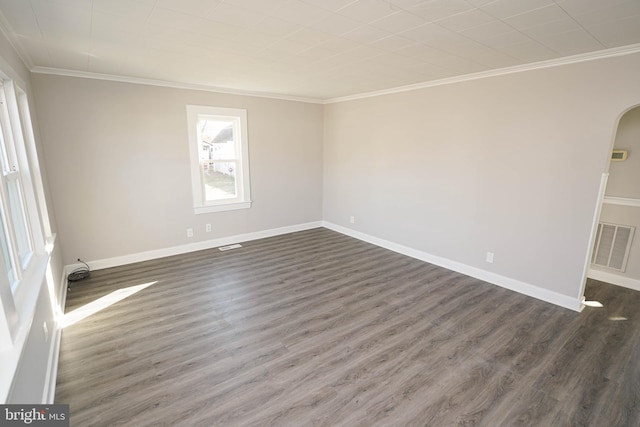 spare room featuring crown molding and dark hardwood / wood-style flooring