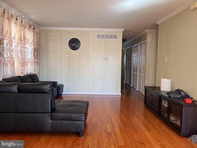 living room featuring ornamental molding and light wood-type flooring