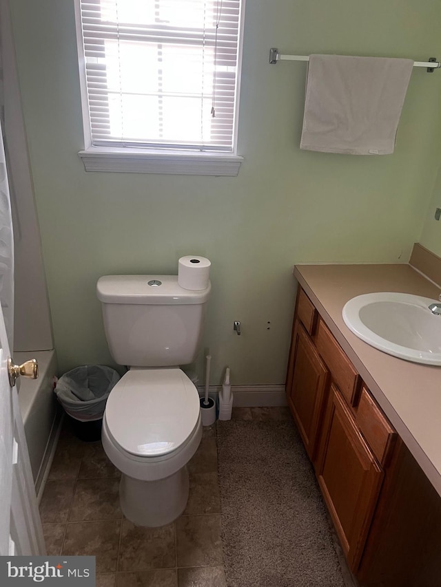 bathroom featuring tile patterned floors, vanity, and toilet