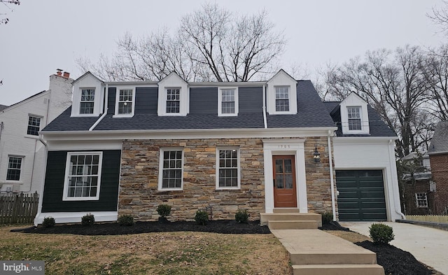 cape cod home featuring a garage