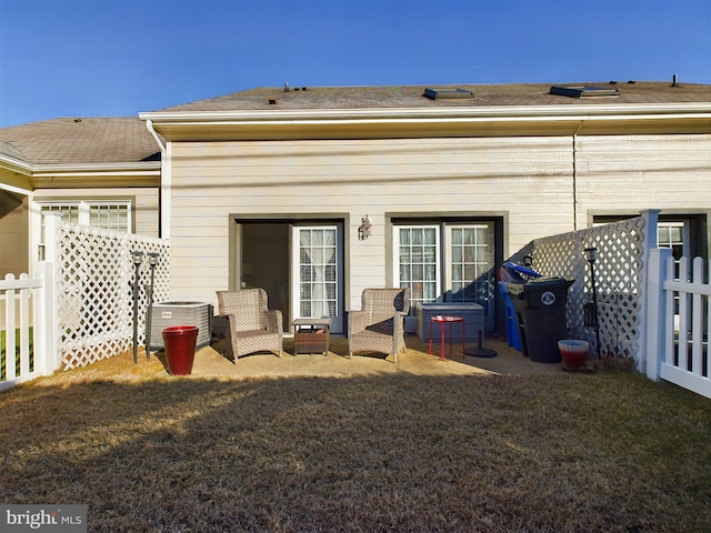 rear view of property featuring central AC and a patio area