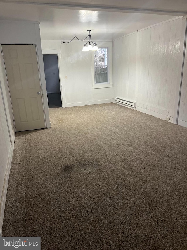 carpeted empty room featuring a notable chandelier and a baseboard radiator