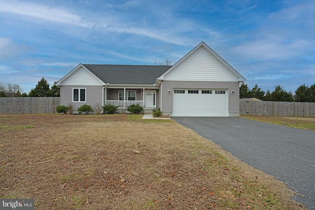 single story home featuring covered porch, driveway, an attached garage, and fence