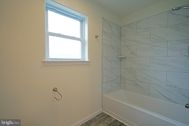 full bath featuring shower / bath combination, baseboards, and wood finished floors