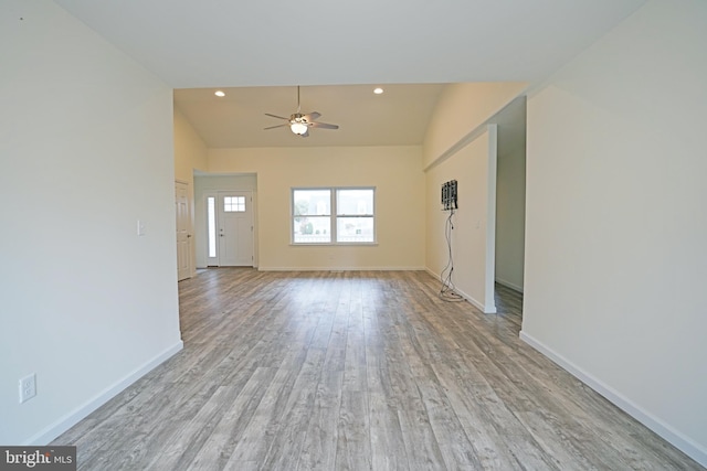 unfurnished living room featuring a ceiling fan, recessed lighting, light wood-style flooring, and baseboards