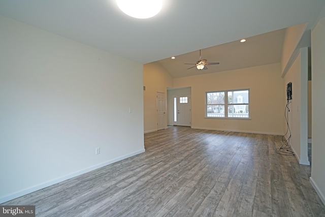 unfurnished living room featuring recessed lighting, wood finished floors, and baseboards